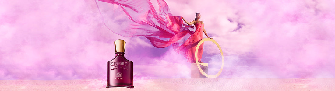 Carmina 75ml bottle in the sand with a model