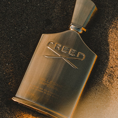 Millseime Imperial 100ml bottle in the sand