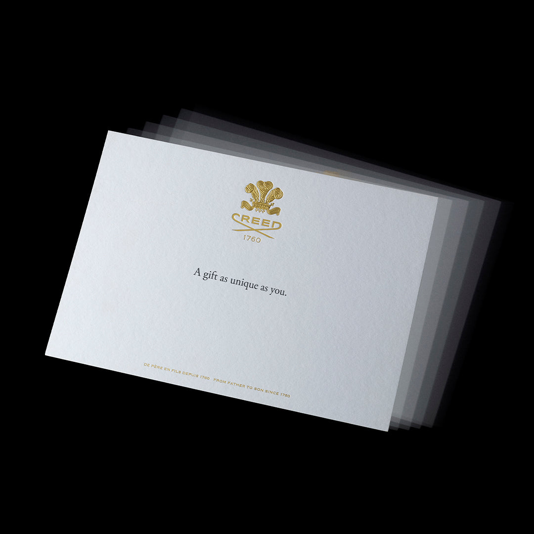 Creed gift card with embossed logo and luxury white design.