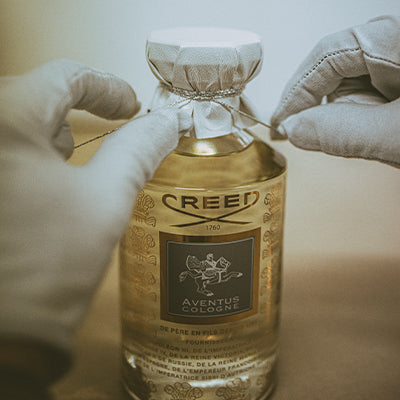 A 1000ml Aventus Cologne being packaged