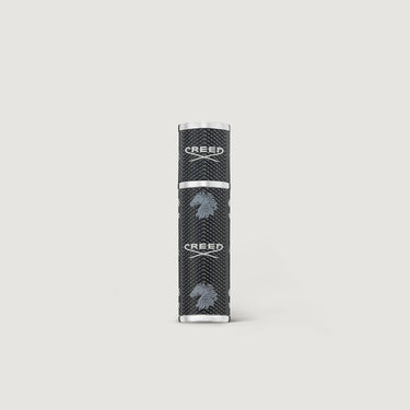 Black and silver cylindrical product on a light gray background
