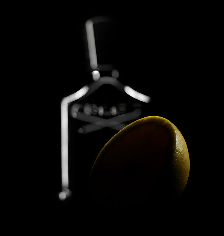 A black background with a creed bottle in the background as well as a yellow fruit