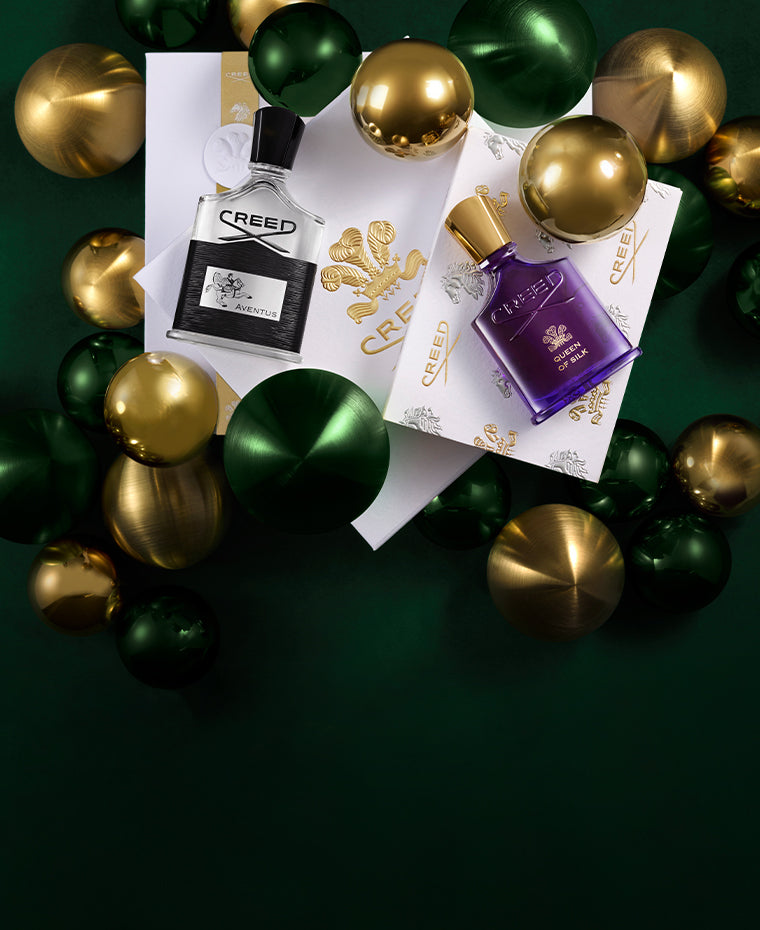 Aventus and Queen of Silk on the holiday gift box featuring yellow and green ornaments.