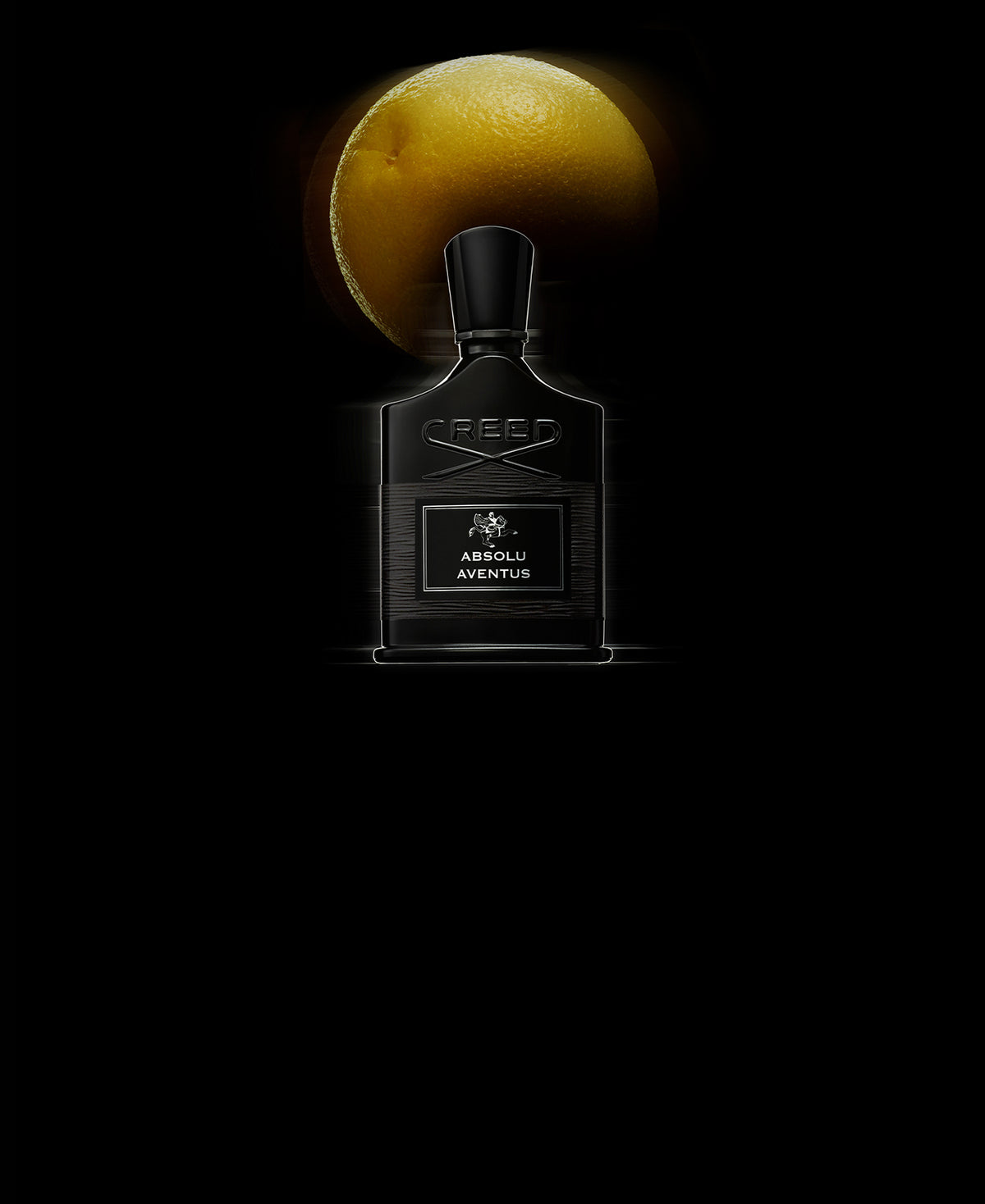 Absolu Aventus with a grapefruit in the background.