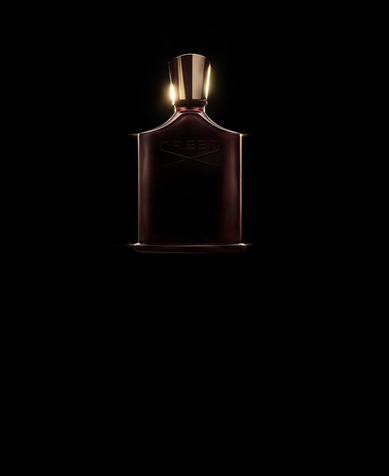 Creed Oud Zarian perfume bottle with gold cap and a dark and dramatic background