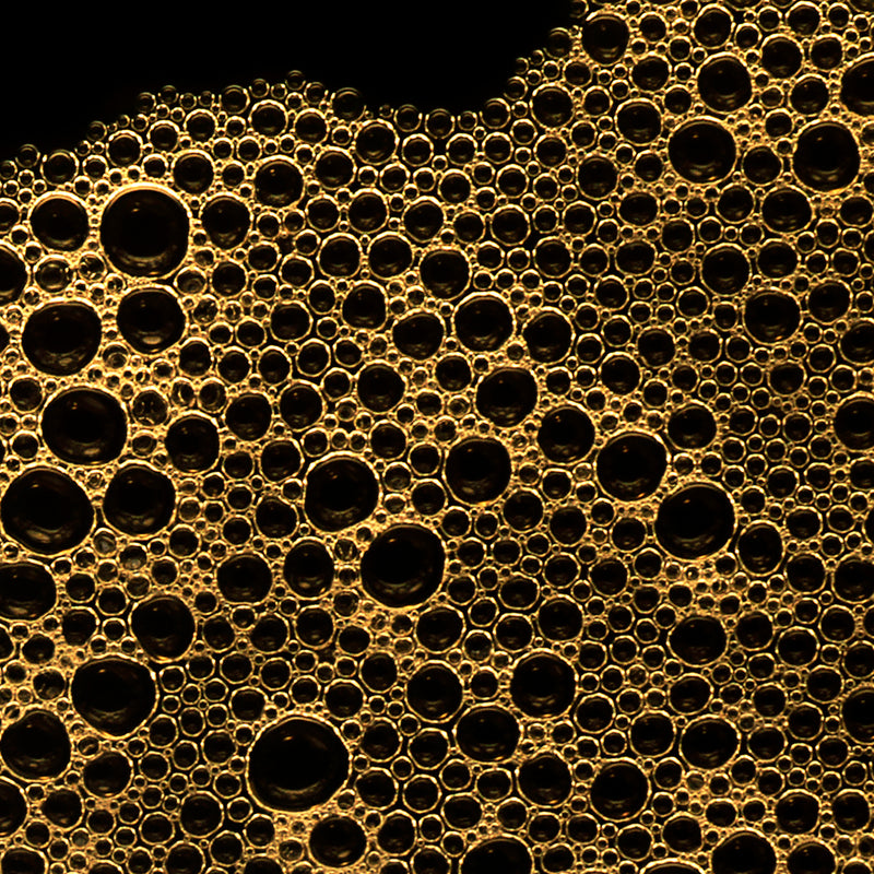Close-up of gold bubbles on a black background
