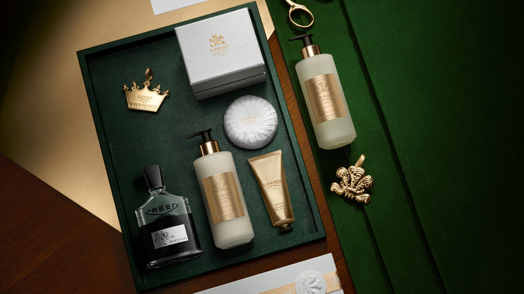 Grooming products including bottles and a brush on a green tray with a crown emblem.