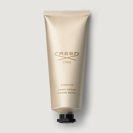 Creed Aventus hand cream tube on a light gray background