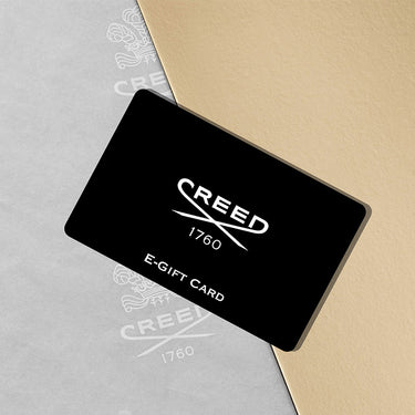 Black e-gift card with 'Creed 1760' logo on a gray and beige background