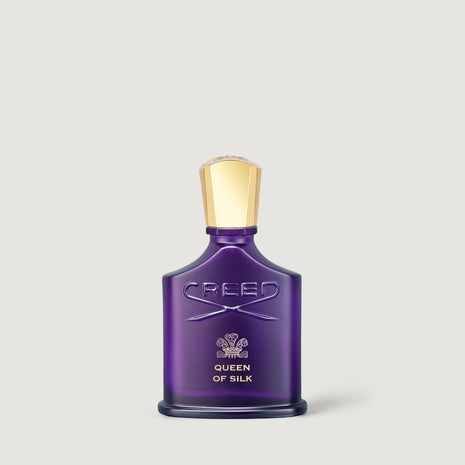 Creed Queen of Silk Eau de Parfum bottle in a deep purple glass with a metallic gold cap, centered on a light gray background.