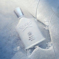 Reed Silver Mountain Water perfume bottle on a snowy background